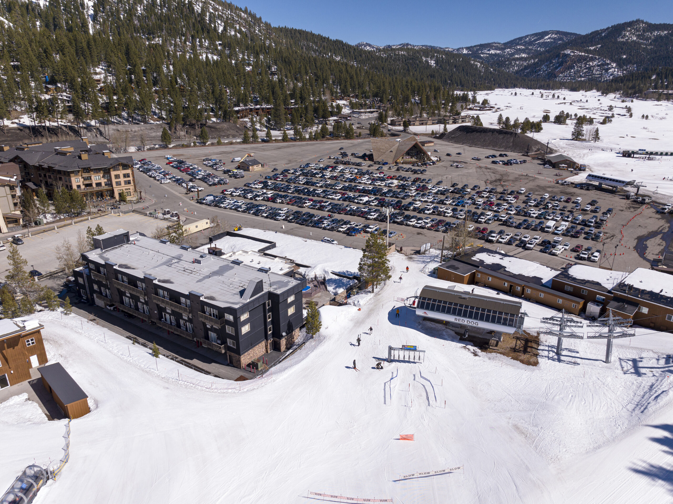 aerial view of snow, parking lot, buildings